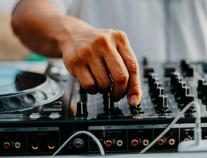 a dj mixing a track on a turntable